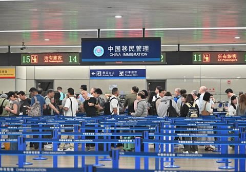 SHANGHAI, CHINA - SEPTEMBER 15: Russian passengers queue up to fill out foreigner entry cards at Shanghai Pudong International Airport on September 15, 2025 in Shanghai, China. On September 2, China announced a trial visa-free policy for Russian citizens holding ordinary passports, effective from September 15, 2025, to September 14, 2026. (Photo by VCG/VCG via Getty Images)