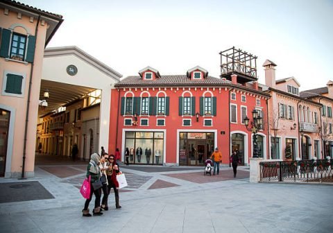 TIANJIN, CHINA - 2014/12/01: Chinese consumers in Florentia Village.  The Florentia Village,  a replica of Italian town,  located in Wuqing, an outskirt station  between Beijing and Tianjin, is a luxury and fashion outlet mall retail park.    Nearly all the consumers take intercity high-speed rail here from Beijing or Tianjin.  In addition to two new openings in 2015, Florentia hopes to open seven outlets across the mainland, extending to second-tier cities such as Chengdu and Qingdao by 2017. (Photo by Zhang Peng/LightRocket via Getty Images)